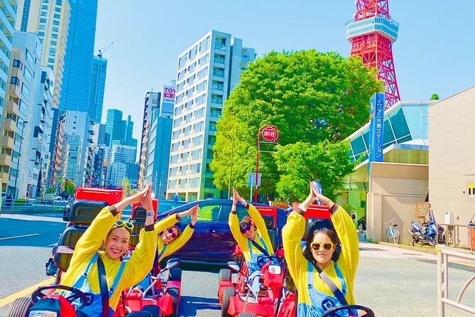 Tourists in go-karts pose in the shape of Tokyo Tower which stands elegantly in the background. The colors of their yellow Minion costumes and the red of the tower lend a bright cheeriness to the image.